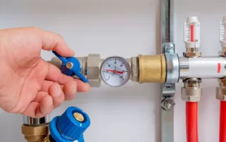hand turning knob on a water pressure regulator