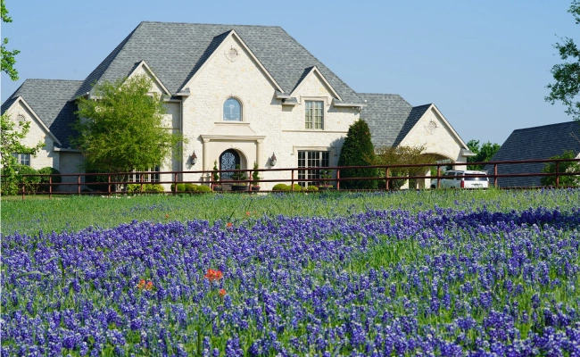 Residential home in the Texas Hill Country with Texas bluebonnets.
