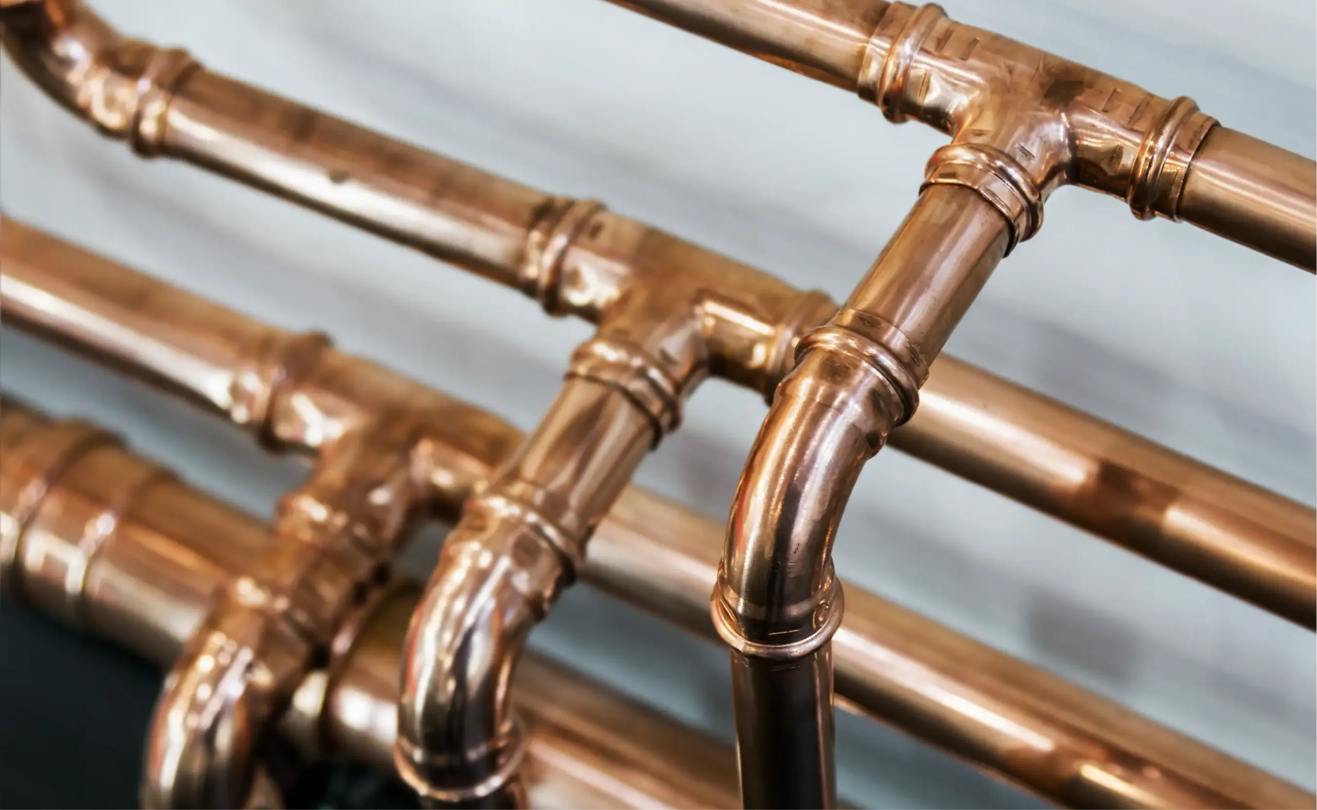 Shiny copper pipes in a home.