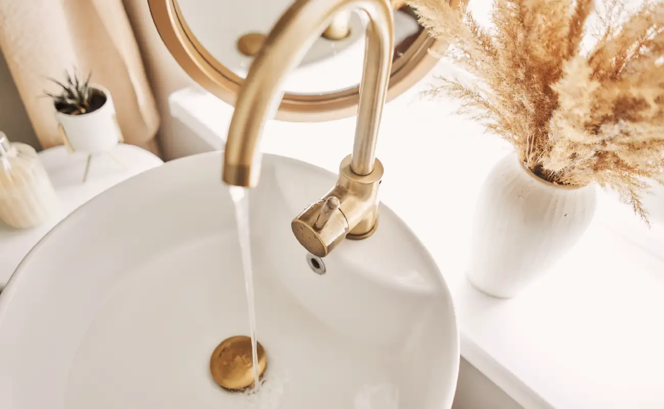 Sink in bathroom with running water.